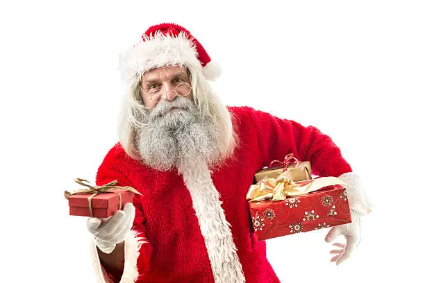 Photo of santa claus holding a present isolated on white