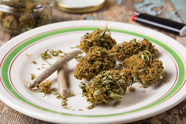 istock Marijuana buds and joints in the white plate 615833140
