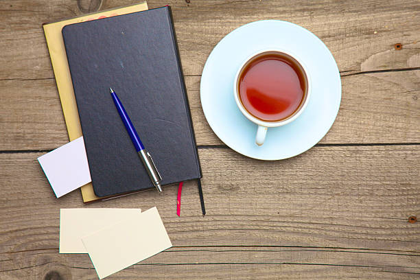 istock Blank business cards with pen, notebook and tea cup on 615833826