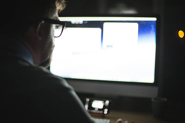 istock Man in front of computer monitor, working 615834610