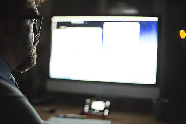 istock Man in front of computer monitor, working 615834686
