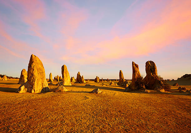 The Pinnacles Western Australia Sunset Composite Composite shot of the Pinnacles in Western Australia, an eerie landscape littered with limestone columns. western australia stock pictures, royalty-free photos & images