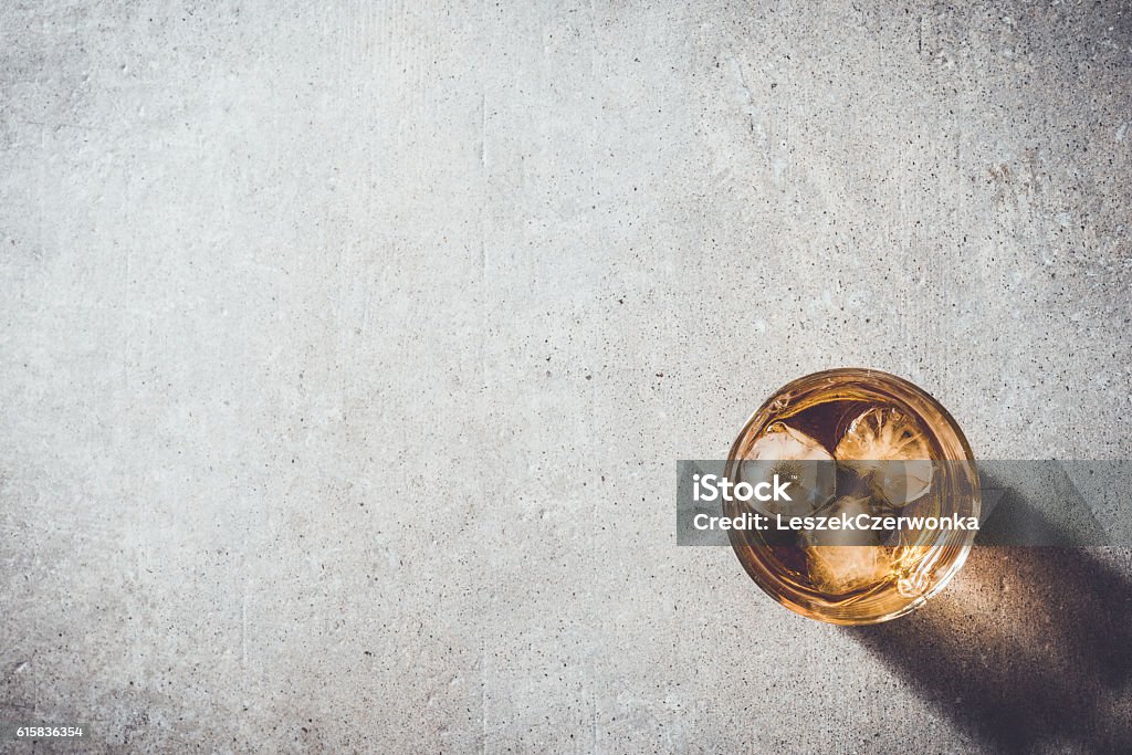 Glass of whiskey Glass of whiskey on gray stone table Whiskey Stock Photo