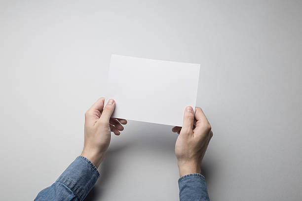 istock Hand holding Blank A5 Flyer / Invitation Mock-up. 615837602