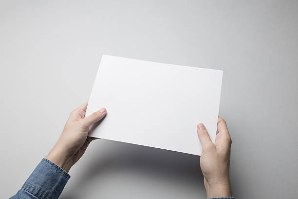 istock Hand holding Blank A$ Flyer / Invitation Mock-up. 615837626