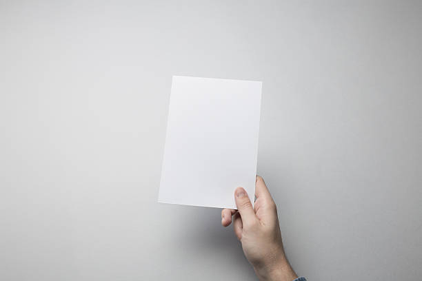 istock Hand holding Blank A5 Flyer / Invitation Mock-up. 615837668