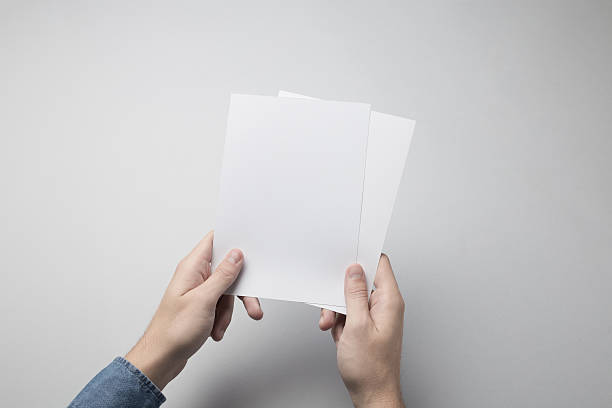 istock Hand holding Blank A5 Flyer / Invitation Mock-up. 615837738