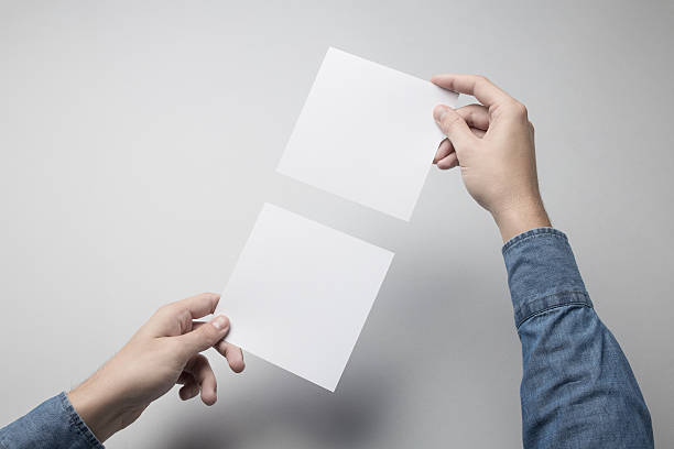 istock Hand holding Blank Square Flyer / Invitation Mock-up 615837812