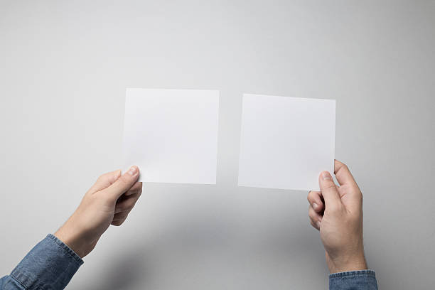 istock Hand holding Blank Square Flyer / Invitation Mock-up 615837888