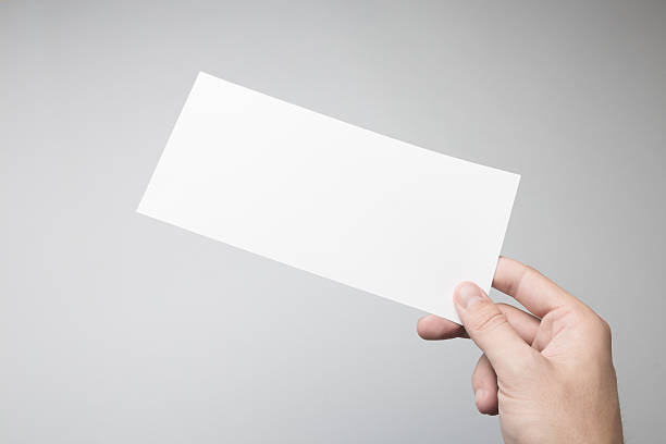 istock Hand holding Blank DL Flyer / Invitation Mock-up. 615838398