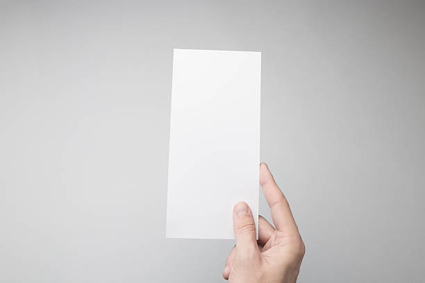 istock Hand holding Blank DL Flyer / Invitation Mock-up. 615838424