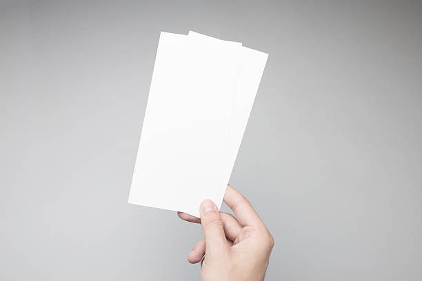 istock Hand holding Blank DL Flyer / Invitation Mock-up. 615838518