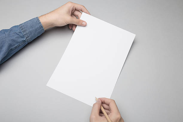 istock Hand is drawing / writing on a A4 blank paper. 615838614