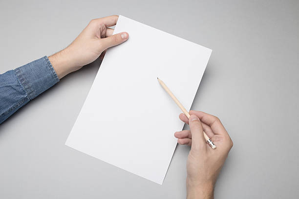 istock Hand is drawing / writing on a A4 blank paper. 615838654