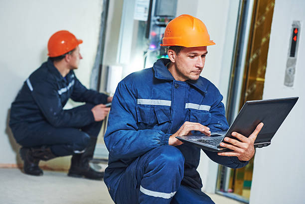 istock Two electrician works with electronic equipment 615840582