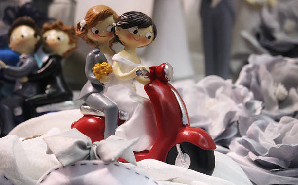 Gay couples Statues of gay couples on motorbikes after their weddings two men same clothes stock pictures, royalty-free photos & images