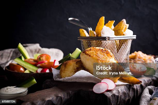 Fried Fish Fillet With Baked Potatoes Stock Photo - Download Image Now - Backgrounds, Bar - Drink Establishment, British Culture