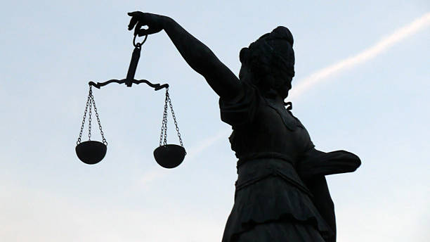 istock Lady Justice Holding Weight Scale By The Left Hand Side 615882414