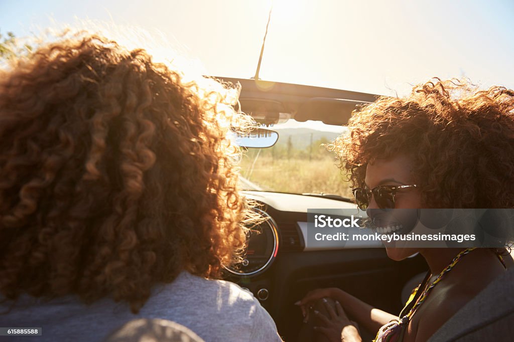 Couple in an open top car, rear passenger point of Couple in an open top car, rear passenger point of view Car Stock Photo