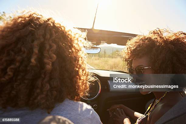 Couple In An Open Top Car Rear Passenger Point Of Stock Photo - Download Image Now - Car, Couple - Relationship, Smiling