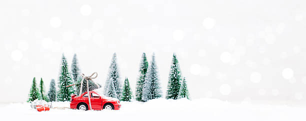 floresta de inverno com carro vermelho em miniatura carregando uma árvore de natal - schneelandschaft - fotografias e filmes do acervo