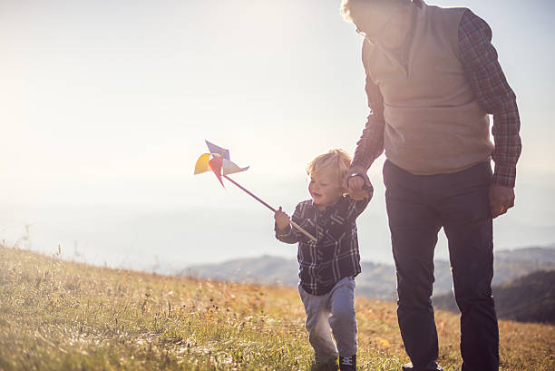 istock Grandfather and grandson in nature 615887992