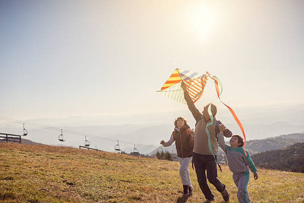 istock Flying a kite with Grandfather 615888550
