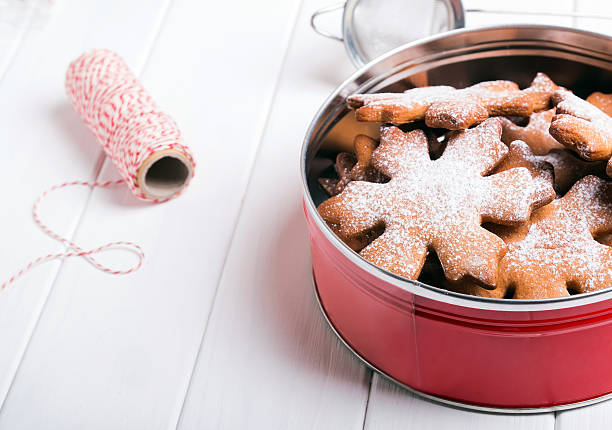Christmas cookies sprinkled with sugar on the white wooden table
