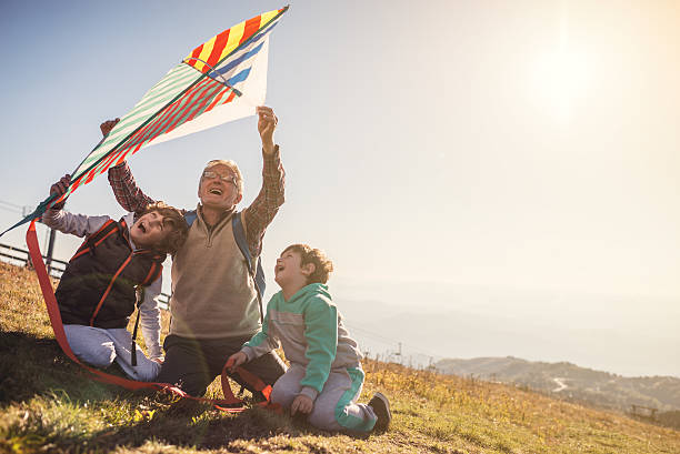 istock Flying a kite with Grandfather 615888998