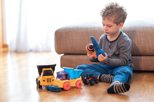 istock Little boy playing with toys 615889026