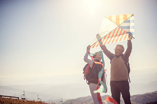 istock Flying a kite with Grandfather 615889496