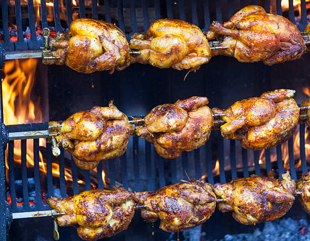 poulet sur une langue de terre - rotisserie chicken barbecue grill food photos et images de collection