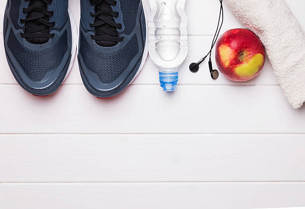 istock Fitness or running stuff on white wooden background 615890164