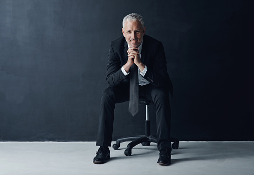 Studio portrait of a mature businessman against a dark background