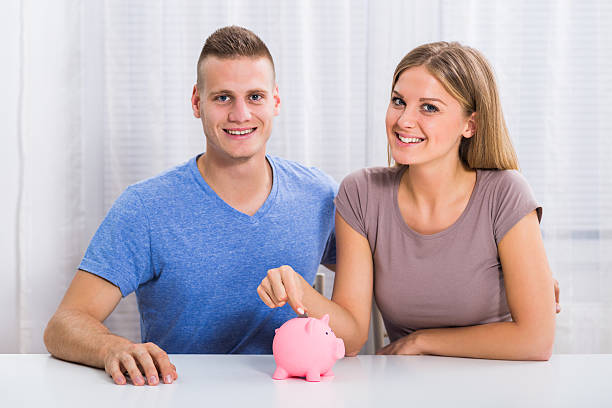 istock Money saving for happy couple 615893580