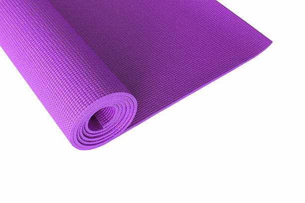 istock Purple yoga mat isolated on white. 615894246