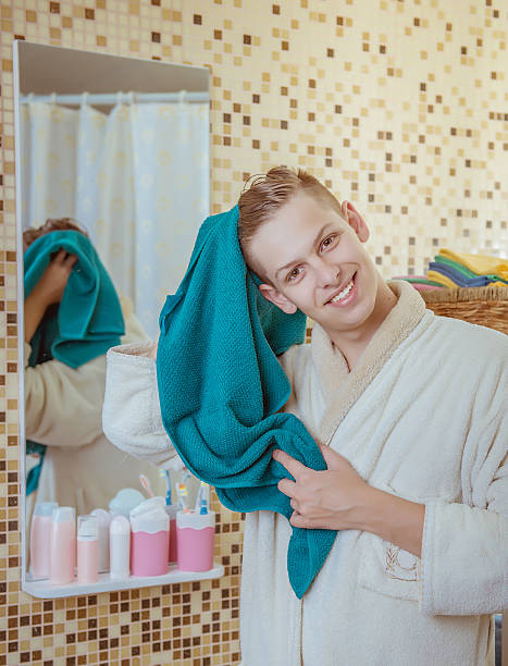 istock Handsome young man drying himself with a towel 615895724