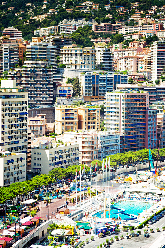 Monte Carlo, Monaco - July 30, 2015: Buildings viewed across the harbour in Monte Carlo. In the bottom of the shot is the outdoor swimming pool and the lido.