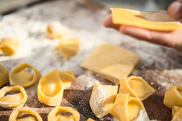 istock chef preparing handmade stuffed pasta tortellini 615897392