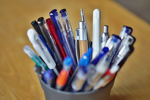 Writing utensils in the business environment with ball pens, highlighters and pens