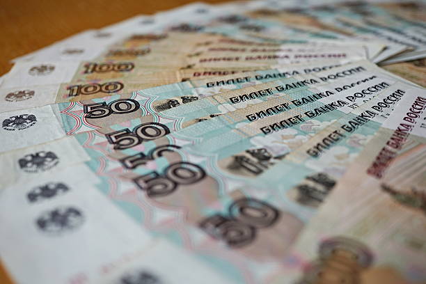 istock bank notes in value of hundred Russian Rubles (RUB) 615898476