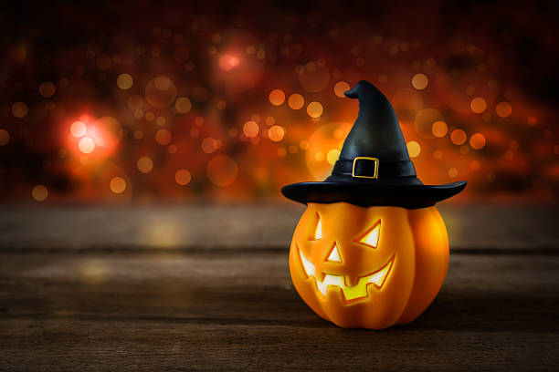 istock Halloween pumpkin head jack lantern on wooden background 615898666