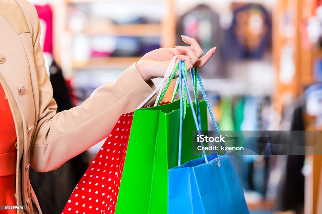 Woman with shopping bags in shop Adult Stock Photo