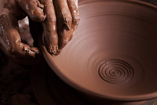 istock Women hands. Potter at work. Creating dishes. Potter's wheel. Di 615900068