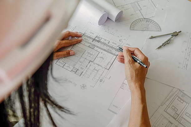 istock Hands of Engineer working on blueprint 615900112