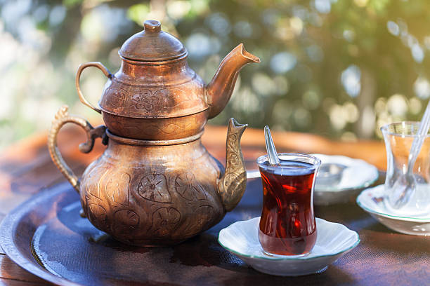istock Drinking Traditional Turkish Tea with Turkish tea cup and copper 615900152