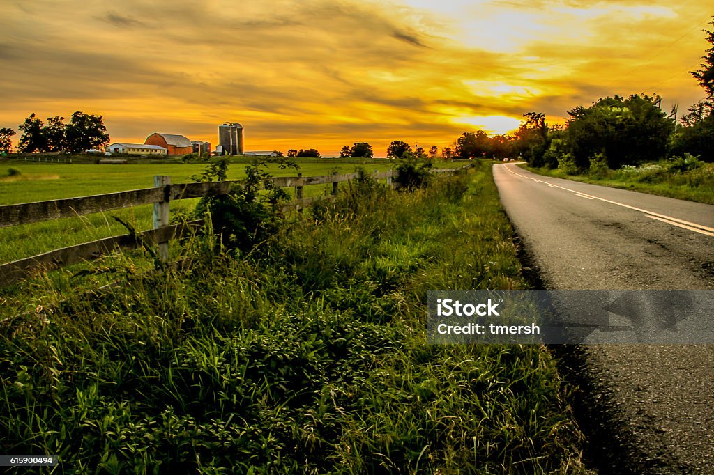 Country Roads Sunset in the country. Rural Scene Stock Photo