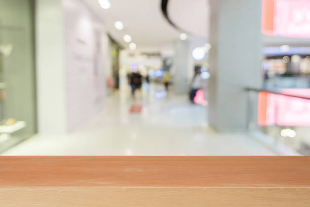 istock Wooden board empty table blurred background in department store 615901390
