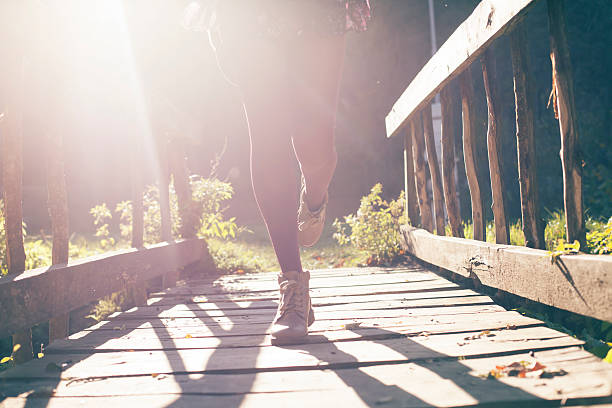 istock Young woman running on a bridge 615902168