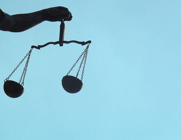 istock Lady Justice Holding Weight Scale With Left Hand Plus Sky 615902606